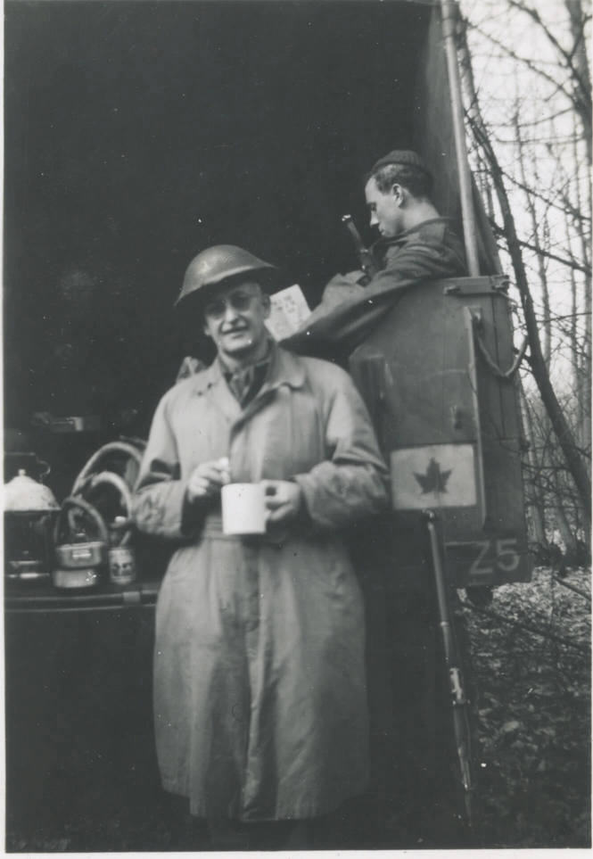 England (March 1942)
Capt. Freele with his cup of tea. Laurie Herbert fast asleep in back of our truck. Notice the kettle boiling on the stove in truck. On a scheme in south of England.
